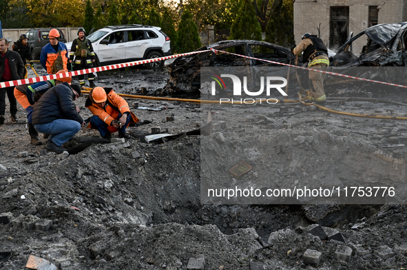 Workers are at the crater from a Russian guided bomb at an oncology dispensary in Zaporizhzhia, Ukraine, on November 7, 2024. Eight people,...