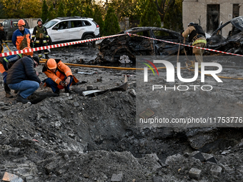 Workers are at the crater from a Russian guided bomb at an oncology dispensary in Zaporizhzhia, Ukraine, on November 7, 2024. Eight people,...