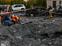 Workers are at the crater from a Russian guided bomb at an oncology dispensary in Zaporizhzhia, Ukraine, on November 7, 2024. Eight people,...