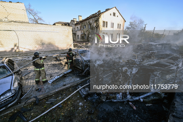 Firefighters extinguish a fire in a car at an oncology dispensary damaged by a Russian guided bomb in Zaporizhzhia, Ukraine, on November 7,...