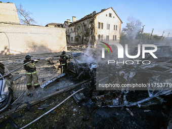 Firefighters extinguish a fire in a car at an oncology dispensary damaged by a Russian guided bomb in Zaporizhzhia, Ukraine, on November 7,...