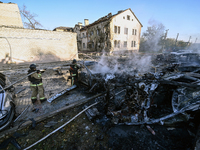 Firefighters extinguish a fire in a car at an oncology dispensary damaged by a Russian guided bomb in Zaporizhzhia, Ukraine, on November 7,...