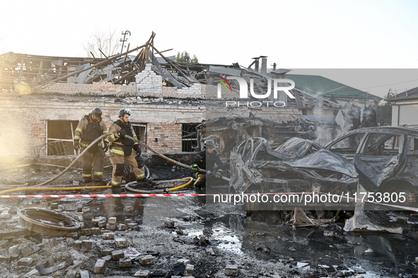 Rescuers extinguish a burning car at an oncology dispensary damaged by a Russian guided bomb in Zaporizhzhia, Ukraine, on November 7, 2024....