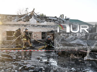 Rescuers extinguish a burning car at an oncology dispensary damaged by a Russian guided bomb in Zaporizhzhia, Ukraine, on November 7, 2024....