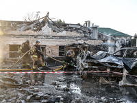 Rescuers extinguish a burning car at an oncology dispensary damaged by a Russian guided bomb in Zaporizhzhia, Ukraine, on November 7, 2024....