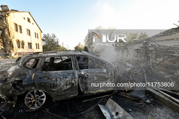 Rescuers extinguish a fire in a car at an oncology dispensary damaged by a Russian guided bomb in Zaporizhzhia, Ukraine, on November 7, 2024...