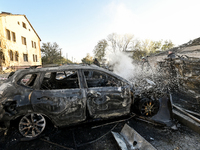 Rescuers extinguish a fire in a car at an oncology dispensary damaged by a Russian guided bomb in Zaporizhzhia, Ukraine, on November 7, 2024...