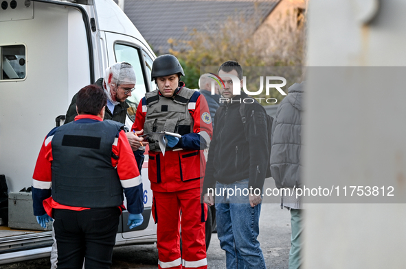 Paramedics provide first aid to an injured man by an ambulance after a Russian guided bomb in Zaporizhzhia, southeastern Ukraine, on Novembe...