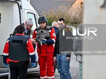 Paramedics provide first aid to an injured man by an ambulance after a Russian guided bomb in Zaporizhzhia, southeastern Ukraine, on Novembe...