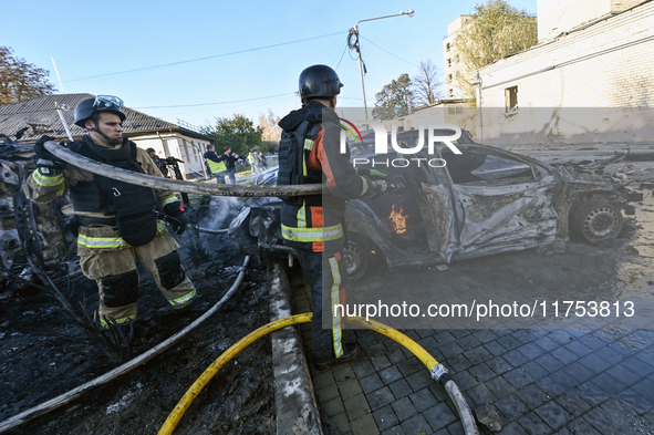 Firefighters extinguish a fire in a car at an oncology dispensary damaged by a Russian guided bomb in Zaporizhzhia, Ukraine, on November 7,...