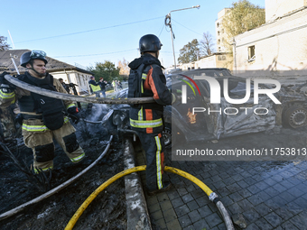 Firefighters extinguish a fire in a car at an oncology dispensary damaged by a Russian guided bomb in Zaporizhzhia, Ukraine, on November 7,...