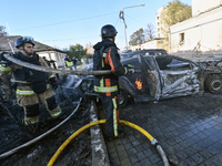 Firefighters extinguish a fire in a car at an oncology dispensary damaged by a Russian guided bomb in Zaporizhzhia, Ukraine, on November 7,...