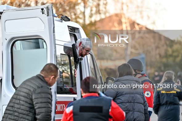 An injured man exits an ambulance after a Russian guided bomb attack in Zaporizhzhia, Ukraine, on November 7, 2024. Eight people, including...