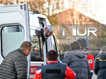 An injured man exits an ambulance after a Russian guided bomb attack in Zaporizhzhia, Ukraine, on November 7, 2024. Eight people, including...