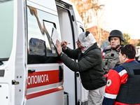 An injured man signs papers by an ambulance after a Russian guided bomb in Zaporizhzhia, Ukraine, on November 7, 2024. Eight people, includi...