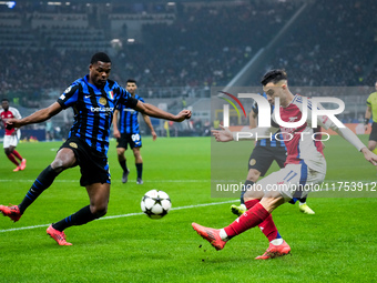 Denzel Dumfries of FC Internazionale and Gabriel Martinelli of Arsenal compete for the ball during the UEFA Champions League 2024/25 League...