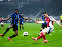 Denzel Dumfries of FC Internazionale and Gabriel Martinelli of Arsenal compete for the ball during the UEFA Champions League 2024/25 League...