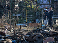 People stand among the debris of a damaged building after an overnight Russian drone attack in Odesa, Ukraine, on November 8, 2024. One pers...