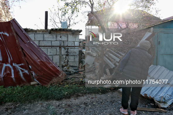 A woman looks at a building damaged by an overnight Russian drone attack in Odesa, Ukraine, on November 8, 2024. One person is killed and ni...