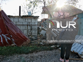 A woman looks at a building damaged by an overnight Russian drone attack in Odesa, Ukraine, on November 8, 2024. One person is killed and ni...