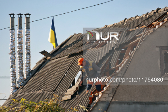 A man is on the roof of a house damaged by an overnight Russian drone attack in Odesa, Ukraine, on November 8, 2024. One person is killed an...