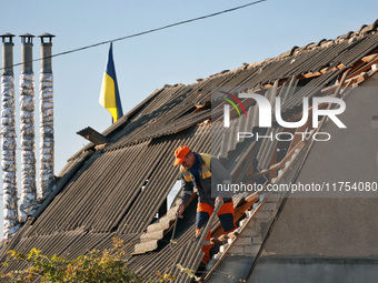 A man is on the roof of a house damaged by an overnight Russian drone attack in Odesa, Ukraine, on November 8, 2024. One person is killed an...