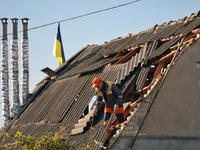 A man is on the roof of a house damaged by an overnight Russian drone attack in Odesa, Ukraine, on November 8, 2024. One person is killed an...