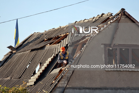 A man is on the roof of a house damaged by an overnight Russian drone attack in Odesa, Ukraine, on November 8, 2024. One person is killed an...