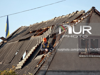 A man is on the roof of a house damaged by an overnight Russian drone attack in Odesa, Ukraine, on November 8, 2024. One person is killed an...