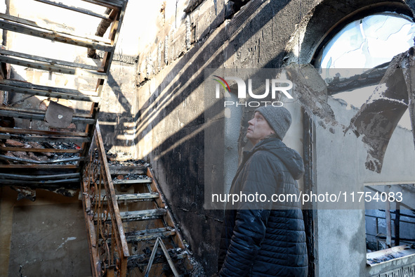 A man looks at a staircase in a house that burns down as a result of an overnight Russian drone attack in Odesa, Ukraine, on November 8, 202...