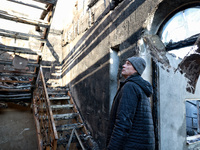 A man looks at a staircase in a house that burns down as a result of an overnight Russian drone attack in Odesa, Ukraine, on November 8, 202...