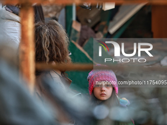 A girl stands near a building damaged by an overnight Russian drone attack in Odesa, Ukraine, on November 8, 2024. One person dies and nine...