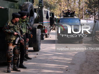 Indian Army soldiers stand alert near the encounter site after killing two militants in Sopore, Jammu and Kashmir, India, on November 8, 202...