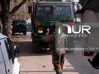 Indian Army soldiers stand alert near the encounter site after killing two militants in Sopore, Jammu and Kashmir, India, on November 8, 202...