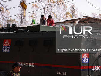 Kashmiri children look on as schools remain closed after an encounter between militants and security forces in which two militants are kille...