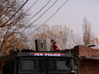 A girl and a boy (siblings) watch the Indian soldiers who engage in an encounter with militants in Sopore, Jammu and Kashmir, India, on Nove...