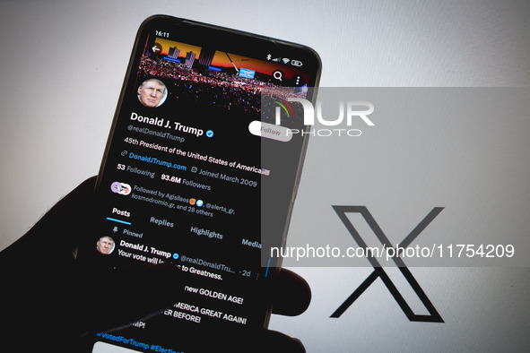 The X (Twitter) account of Donald J. Trump appears on a smartphone screen with the Twitter logo in the background in Athens, Greece, on Nove...