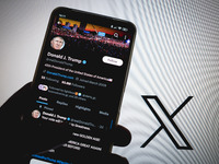 The X (Twitter) account of Donald J. Trump appears on a smartphone screen with the Twitter logo in the background in Athens, Greece, on Nove...