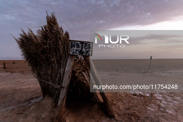 A 'hotel' sign is seen on a grass tent as sun rises over Chott el Djerid salt lake in eastern Sahara, Tunisia on October 29, 2024. Chott el...