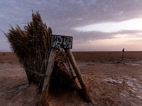 A 'hotel' sign is seen on a grass tent as sun rises over Chott el Djerid salt lake in eastern Sahara, Tunisia on October 29, 2024. Chott el...