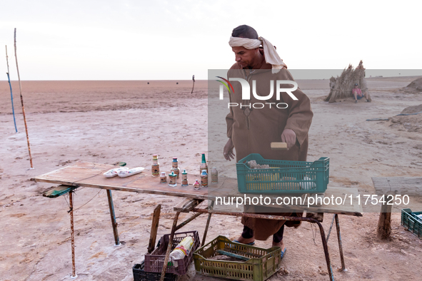 A local bedouin opens his souvenir stand as sun rises over Chott el Djerid salt lake in eastern Sahara, Tunisia on October 29, 2024. Chott e...