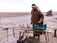 A local bedouin opens his souvenir stand as sun rises over Chott el Djerid salt lake in eastern Sahara, Tunisia on October 29, 2024. Chott e...