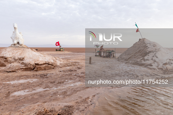 A local bedouin opens his souvenir stand as sun rises over Chott el Djerid salt lake in eastern Sahara, Tunisia on October 29, 2024. Chott e...