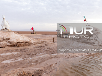 A local bedouin opens his souvenir stand as sun rises over Chott el Djerid salt lake in eastern Sahara, Tunisia on October 29, 2024. Chott e...