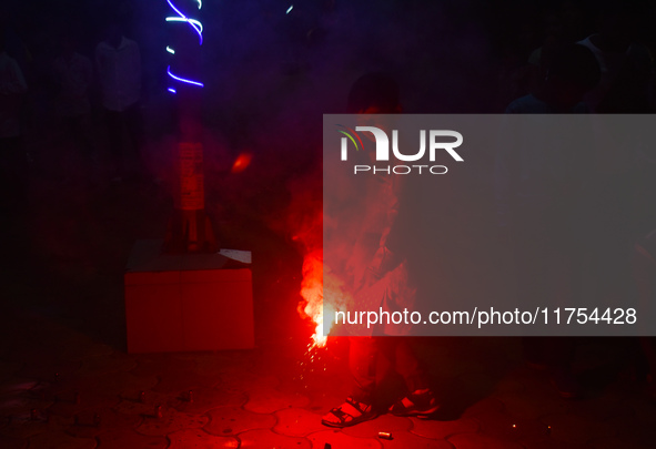 A boy lights fireworks to celebrate the Chhath festival in Kolkata, India, on November 8, 2024. 