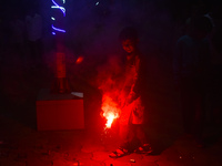 A boy lights fireworks to celebrate the Chhath festival in Kolkata, India, on November 8, 2024. (