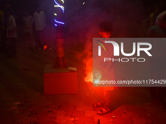 A boy lights fireworks to celebrate the Chhath festival in Kolkata, India, on November 8, 2024. (