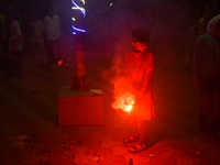 A boy lights fireworks to celebrate the Chhath festival in Kolkata, India, on November 8, 2024. (