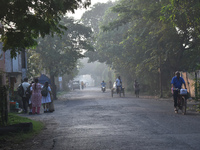 People stand on the street on a polluted, smoggy morning in Kolkata, India, on November 8, 2024. (