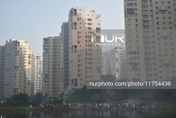 People celebrate the Chhath festival on a polluted, smoggy morning in Kolkata, India, on November 8, 2024. 